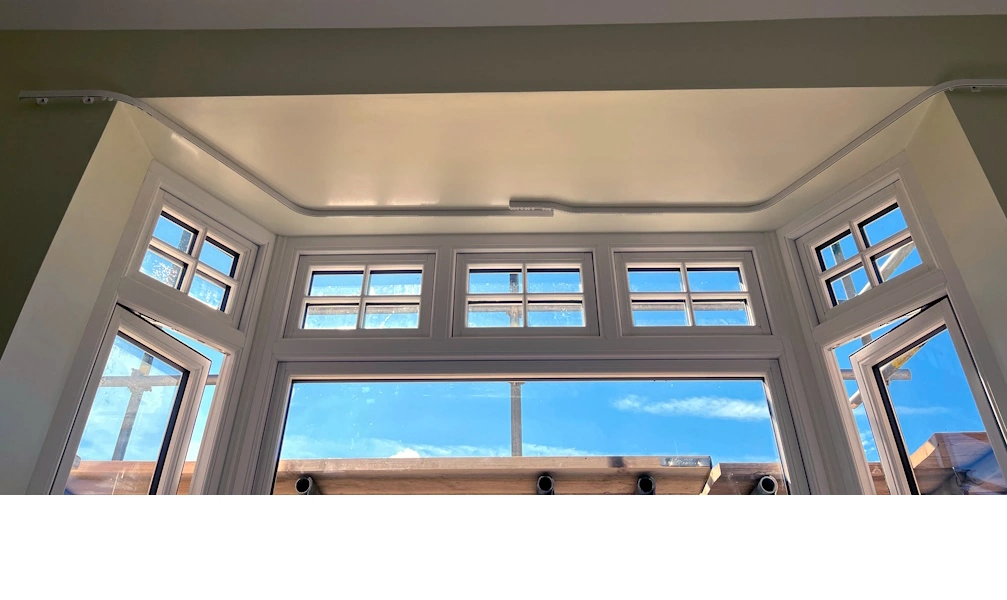Bay track ceiling fitted in the bay and wall fitted on the returns out of the bay