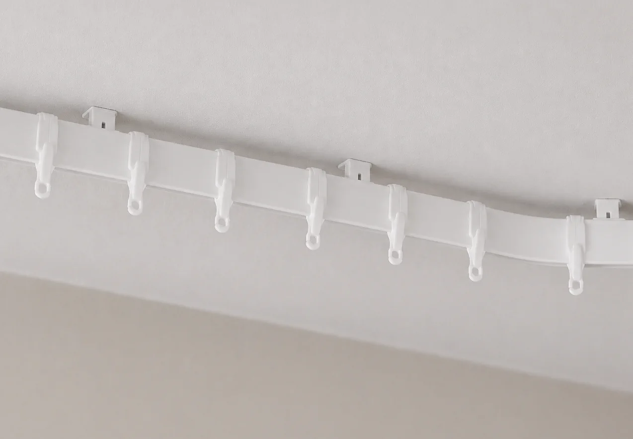 Poorly fitted bay window curtain track with awkward brackets