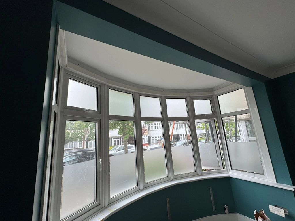 Seven-sided bay window with a supporting beam across the front of the bay