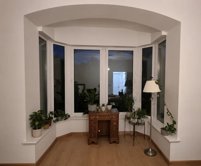 Attractive but very awkward bay window with an arched beam, deep sill and inward-opening windows